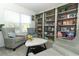 Cozy living room with built-in bookshelves, comfy armchairs, and a stylish coffee table at 328 Conway Ave, Saint Cloud, FL 34771