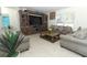 Spacious living room with large windows, tile flooring, and plush seating arranged around coffee table at 328 Conway Ave, Saint Cloud, FL 34771