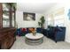 Cozy living area with plush blue furniture, decorative accents, and large windows at 328 Conway Ave, Saint Cloud, FL 34771