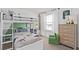 bedroom with a bunk bed, dresser, and green accent wall at 3645 Cambridge Brook Dr, Davenport, FL 33837