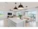 Open kitchen with island, white cabinets, stainless steel appliances and breakfast nook at 3645 Cambridge Brook Dr, Davenport, FL 33837