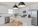 Modern kitchen with white cabinets, stainless steel appliances, and an island at 3645 Cambridge Brook Dr, Davenport, FL 33837