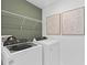 Laundry room with Whirlpool washer and dryer, and modern shelving at 3645 Cambridge Brook Dr, Davenport, FL 33837