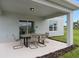 Covered patio with outdoor dining set and adjacent yard at 3645 Cambridge Brook Dr, Davenport, FL 33837