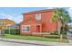Two-story coral home with pool and lush landscaping at 4756 Ormond Beach Way, Kissimmee, FL 34746