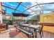 Enclosed patio with dining area, hot tub, and grill at 4756 Ormond Beach Way, Kissimmee, FL 34746
