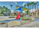 playground with shaded areas and a red slide at 4756 Ormond Beach Way, Kissimmee, FL 34746