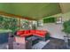 Covered patio with outdoor furniture and lush greenery at 507 Orange Ave, Ocoee, FL 34761