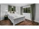 Bright bedroom with a white bedframe, wood floors, and natural light at 507 Orange Ave, Ocoee, FL 34761