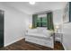 Relaxing bedroom with a daybed, wood floors, and minimalist decor at 507 Orange Ave, Ocoee, FL 34761