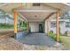 Covered carport with paved parking area and wooden support beams at 507 Orange Ave, Ocoee, FL 34761