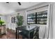 Dining area in living room with view of lush landscaping through window at 507 Orange Ave, Ocoee, FL 34761