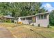 Charming home with covered carport, landscaping, and trees at 507 Orange Ave, Ocoee, FL 34761