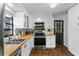 Updated kitchen featuring stainless steel appliances, butcher block counters, and white shaker cabinets at 507 Orange Ave, Ocoee, FL 34761
