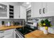 Modern kitchen with stainless steel appliances, wood countertops, and white cabinetry at 507 Orange Ave, Ocoee, FL 34761