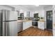 Modern kitchen featuring white shaker cabinets, stainless steel appliances, and wood countertops at 507 Orange Ave, Ocoee, FL 34761