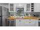 Kitchen with stainless steel appliances, white shaker cabinets, and butcher block countertops at 507 Orange Ave, Ocoee, FL 34761