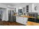 Modern white kitchen with stainless steel appliances, butcher block counters, and wood floors at 507 Orange Ave, Ocoee, FL 34761