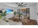 Living room with white walls, wood floors, ceiling fan, and sliding glass door at 507 Orange Ave, Ocoee, FL 34761