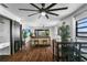 Living room with wood floors, ceiling fan, and dining area at 507 Orange Ave, Ocoee, FL 34761