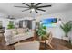 Living room with comfortable seating, wood floors, ceiling fan, and beach-themed artwork at 507 Orange Ave, Ocoee, FL 34761