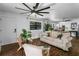 Inviting living room with wood floors, ceiling fan, and ample natural light at 507 Orange Ave, Ocoee, FL 34761
