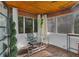 Sunroom/office space with wood ceiling, ample natural light, and glass desk at 507 Orange Ave, Ocoee, FL 34761