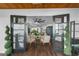 Sunroom entryway with French doors, wood floors, and decorative plants at 507 Orange Ave, Ocoee, FL 34761