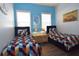 Twin bedroom with geometric bedding and light blue walls at 7503 Mourning Dove Cir # 104, Kissimmee, FL 34747