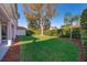 Landscaped backyard with a grassy area, providing a private outdoor space at 11313 Via Andiamo, Windermere, FL 34786
