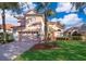 Two-story house with light peach walls, red tile roof, and palm trees at 11313 Via Andiamo, Windermere, FL 34786