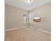 Spacious bedroom with wall-mounted TV and window at 11640 Hampstead St, Windermere, FL 34786