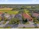 Luxury home with a gray roof and pool in a golf course community at 1239 Radiant St, Reunion, FL 34747