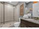 Bathroom with shower, toilet, and granite vanity at 1239 Radiant St, Reunion, FL 34747
