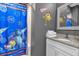 Bathroom with Monsters University shower curtain and granite countertop at 1239 Radiant St, Reunion, FL 34747