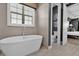 Main bathroom with freestanding tub and adjacent toilet at 1239 Radiant St, Reunion, FL 34747