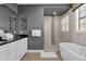 Elegant bathroom with soaking tub, walk-in shower, and double vanity at 1239 Radiant St, Reunion, FL 34747