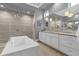 Spa-like bathroom with a freestanding tub, dual vanities, and a large shower at 1239 Radiant St, Reunion, FL 34747