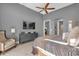 Bright bedroom with large bed, comfy chair, and a wall-mounted TV at 1239 Radiant St, Reunion, FL 34747