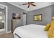 Bedroom with dresser, TV, and yellow pillows at 1239 Radiant St, Reunion, FL 34747