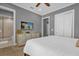 Bedroom with a dresser, TV, and ensuite bathroom at 1239 Radiant St, Reunion, FL 34747