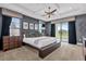 Main bedroom with a king-size bed and access to a balcony at 1239 Radiant St, Reunion, FL 34747