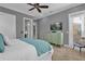 Bedroom with a dresser, TV, and teal bedding at 1239 Radiant St, Reunion, FL 34747