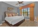 Bedroom with king-size bed and orange accents at 1239 Radiant St, Reunion, FL 34747