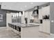 Modern kitchen boasts white cabinetry, granite countertops, and stainless steel appliances at 1239 Radiant St, Reunion, FL 34747