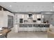 Modern kitchen with white cabinets, granite countertops, and stainless steel appliances at 1239 Radiant St, Reunion, FL 34747