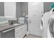 Convenient laundry room with washer, dryer, and utility sink at 1239 Radiant St, Reunion, FL 34747