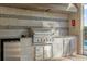 Outdoor kitchen with stainless steel grill and mini fridge at 1239 Radiant St, Reunion, FL 34747