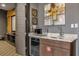 Home wet bar with microwave, wine cooler, and granite countertop at 1239 Radiant St, Reunion, FL 34747
