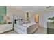 Main bedroom with a king-size bed, ensuite bathroom, and stylish decor at 1249 Limbali St, Mount Dora, FL 32757